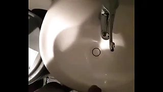Mendicant pissing in sink in restuarant